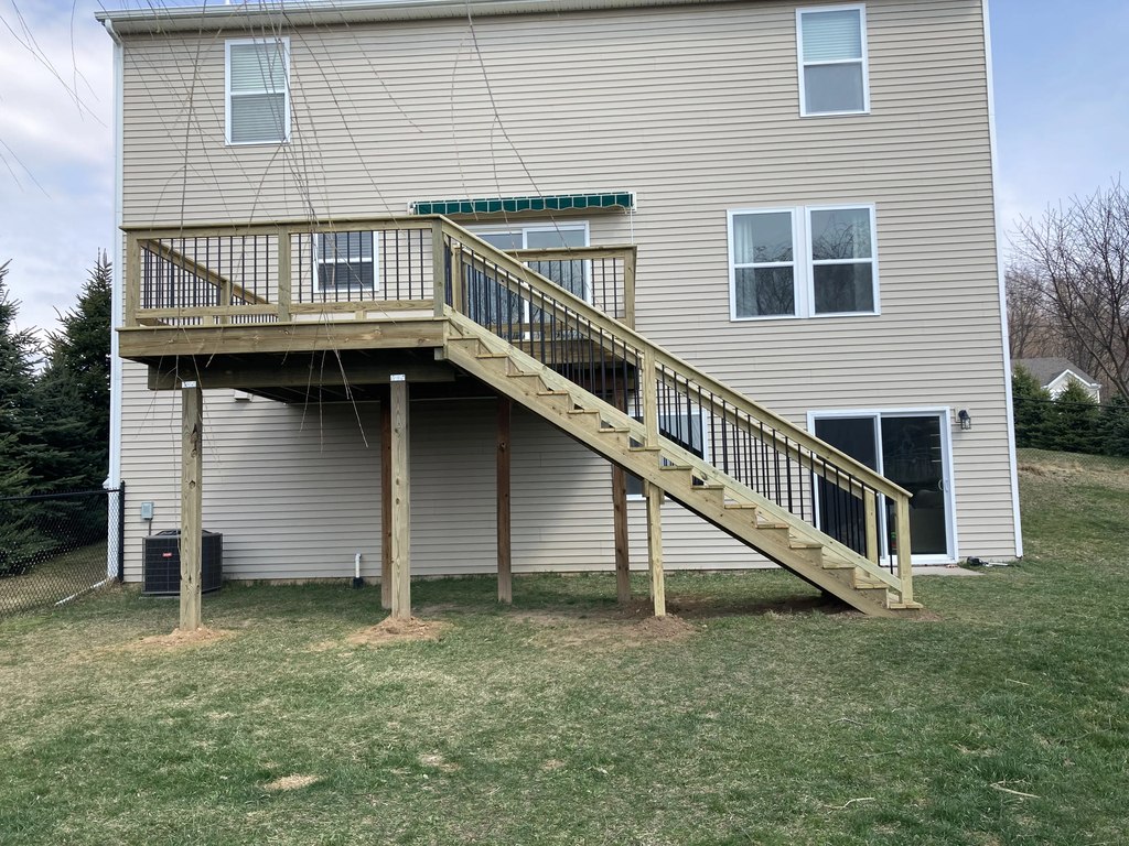 Elevated Pine Deck with Tall Staircase & Black Railings — photo 1