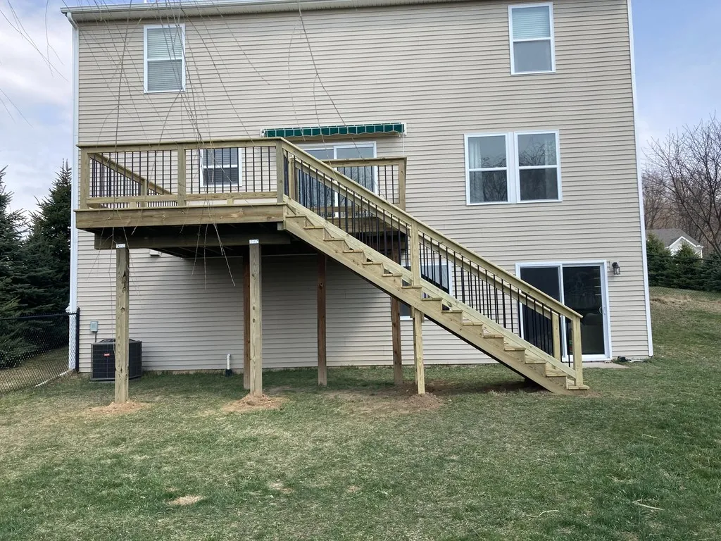 Elevated Pine Deck with Tall Staircase & Black Railings