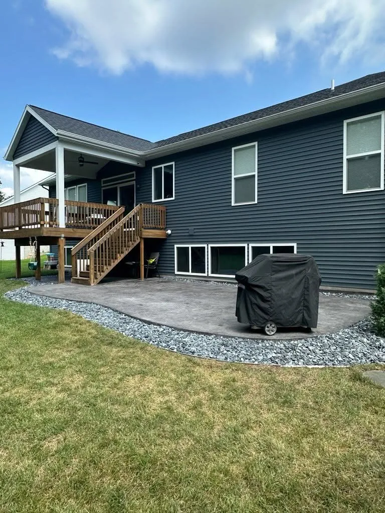 Stamped Concrete Patio Beneath a Covered Deck